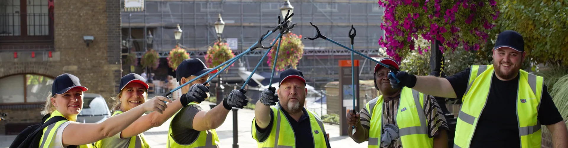 group of Clarksons employees in hi vis jackets with litter pickers