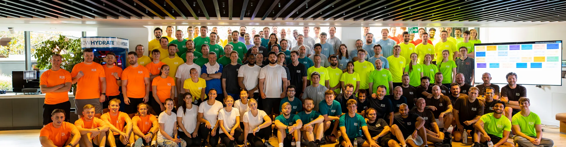 Group photo of diverse people in colorful shirts.