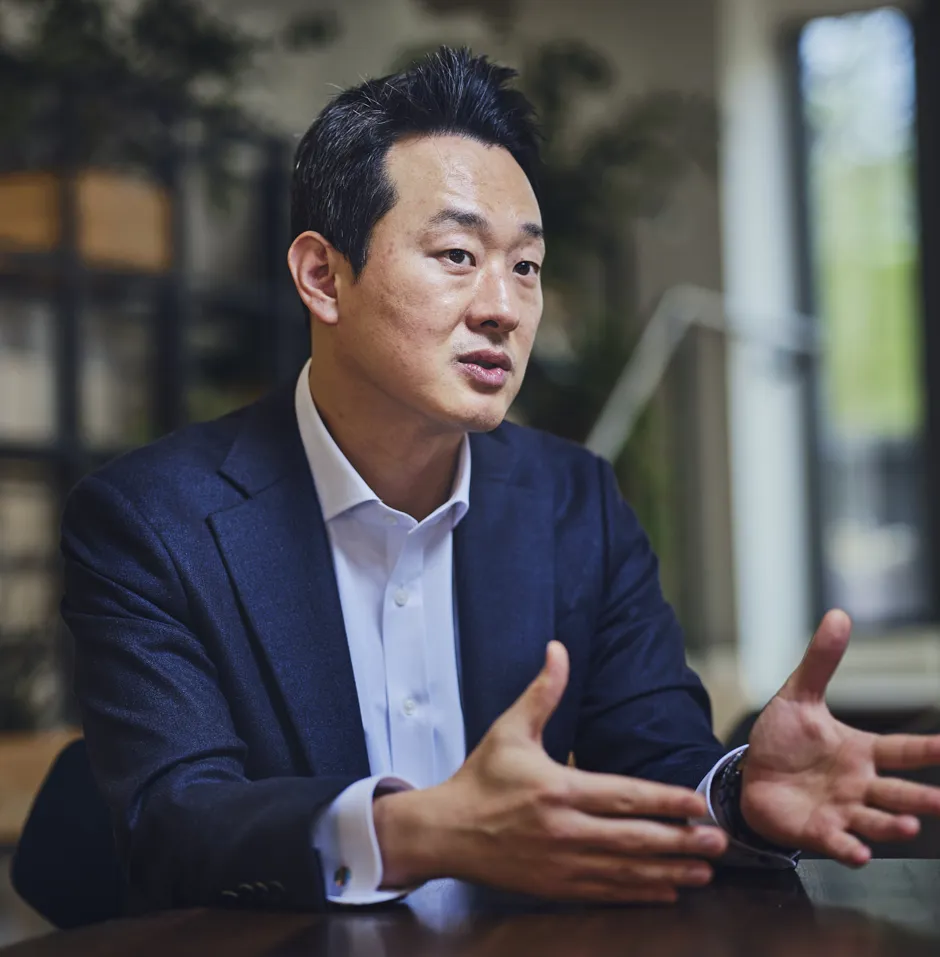 man sitting at table talking and gesturing with hands