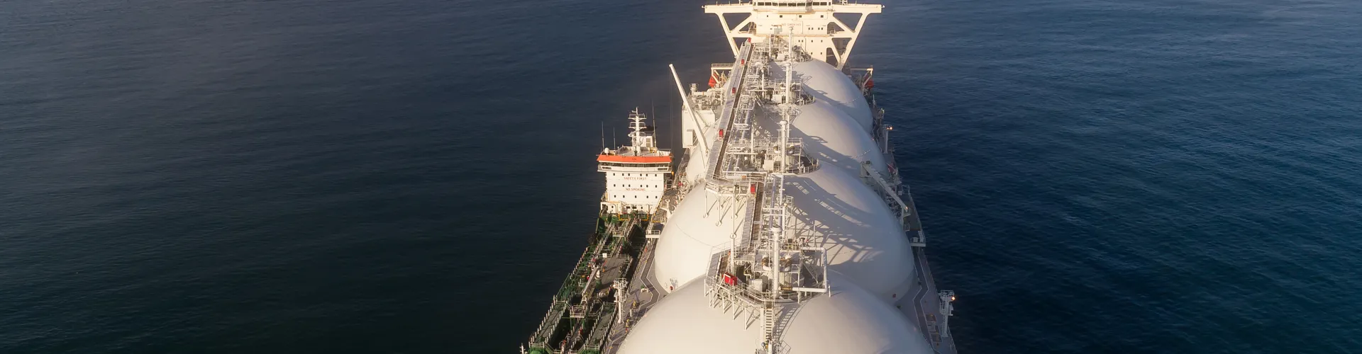 Top view of a large LNG tanker and a tanker standing side by side.