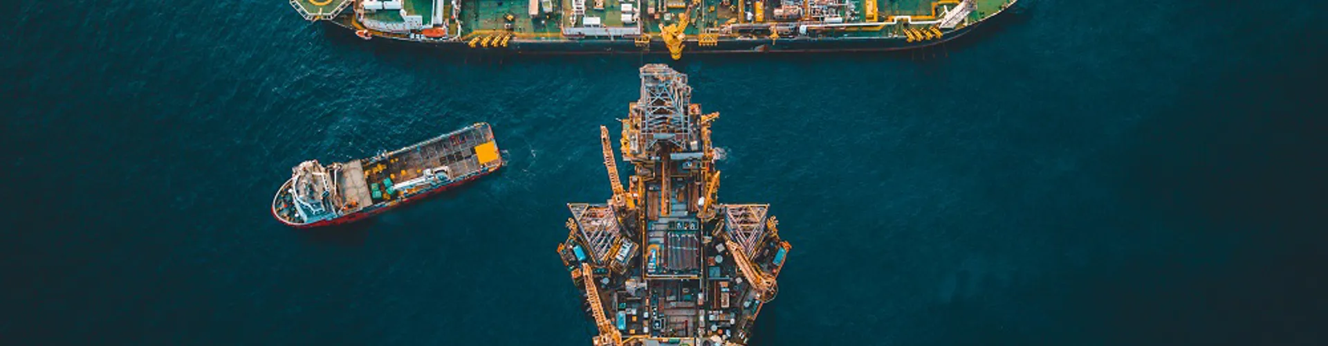 Aerial view of oil rigs in the ocean.